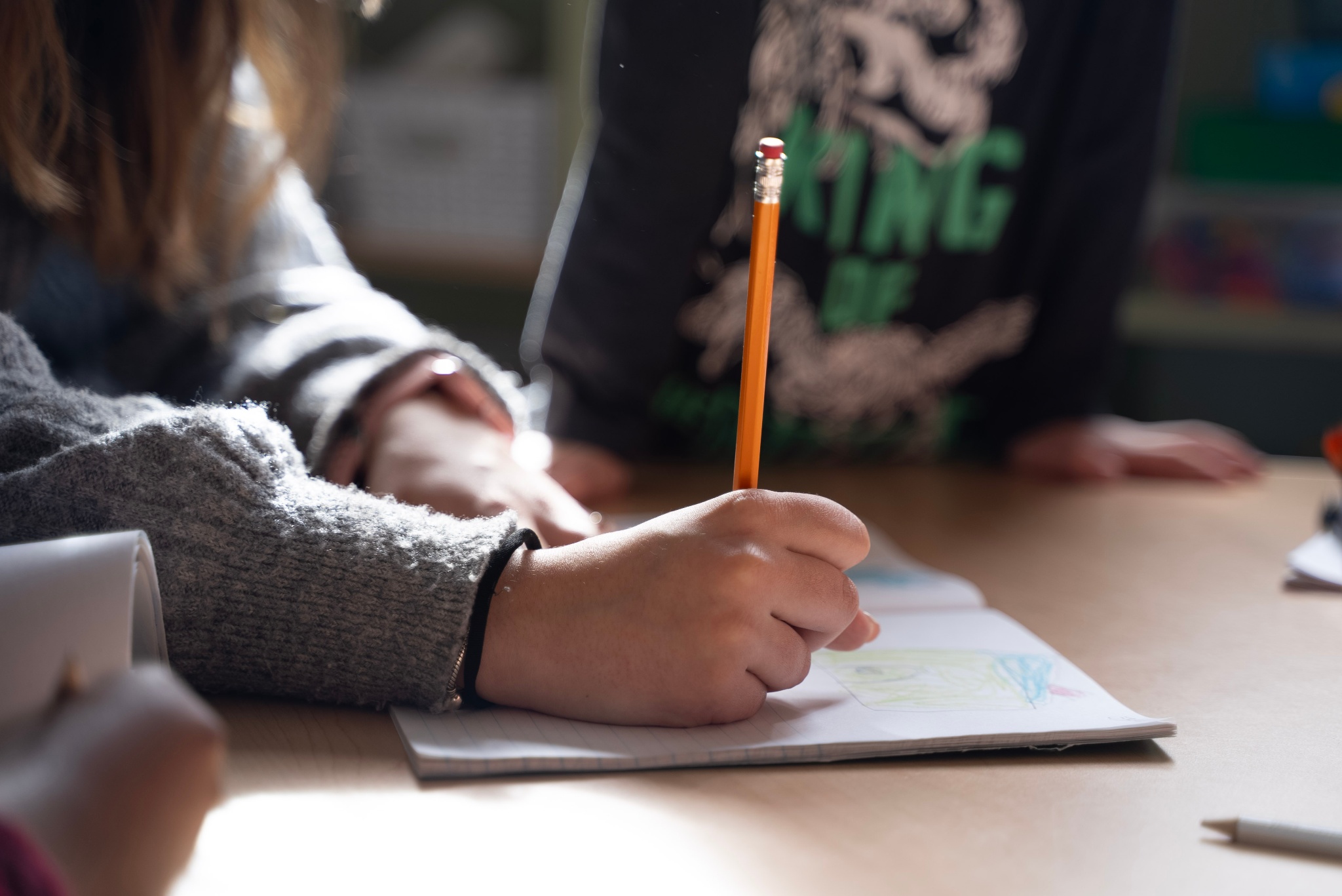 Student writing in a notebook